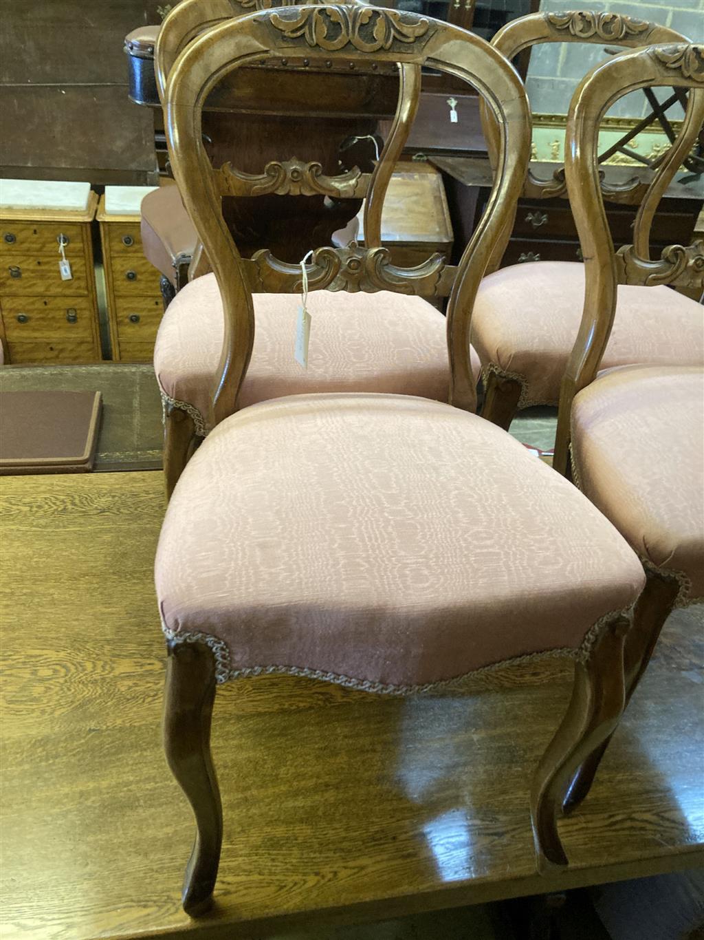 A set of four Victorian walnut balloon back dining chairs